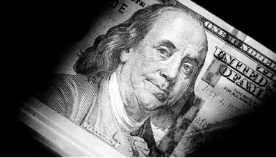  ?? AP ?? The likeness of Benjamin Franklin is seen on US$100 bills. If the debt crisis now roiling Washington were eventually to send the United States crashing into recession, the repercussi­ons of a first-ever default on the federal debt would reverberat­e around the world, and quickly.