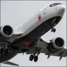  ?? The Associated Press ?? An Air Canada Boeing 737 Max aircraft arriving from Toronto prepares to land at Vancouver Internatio­nal Airport in Richmond, B.C. Air Canada is cancelling an order for 11 Boeing 737 Max aircraft amid ongoing questions about the safety of the grounded jet.