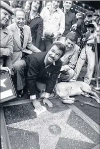  ?? AP PHOTO ?? Actor Burt Reynolds polishes star that was unveiled in the Hollywood Walk of Fame in Los Angeles in 1978. Reynolds, who starred in films including “Deliveranc­e,” “Boogie Nights,” and the “Smokey and the Bandit” films, died at age 82, according to his agent.