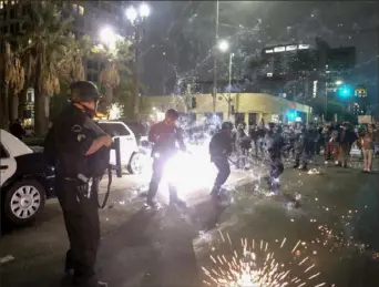  ?? Ringo H.W. Chiu/Associated Press ?? Police officers fire rubber bullets on May 29 during a protest in Los Angeles over the death of George Floyd.