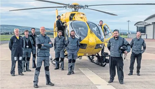  ??  ?? READY TO RESPOND: Captain Andy Lister, head of flight operations in Scotland, fourth from the left, and members of his rotary team