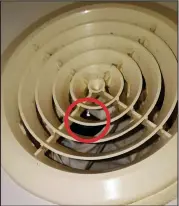  ??  ?? Left: The shower and ventilator where the camera was concealed Right: The glinting camera lens (circled) that was spotted by Miss Hachey