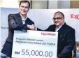  ??  ?? Graham (left) presenting a RM55,000 mock cheque to Ahmad Kamarulnaj­uib.