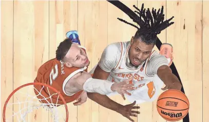  ?? BOB DONNAN/USA TODAY ?? Tennessee forward Jonas Aidoo shoots as Texas guard Chendall Weaver defends March 23 at Spectrum Center in Charlotte, N.C., in the second round of the NCAA Tournament. The Vols won to advance to today’s Sweet 16, where they will play Creighton in Detroit.