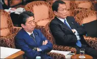  ?? KAZUHIRO NOGI / AGENCE FRANCE-PRESSE ?? Japanese Prime Minister Shinzo Abe (left) and Finance Minister Taro Aso attend an upper house budget committee session in Tokyo on Wednesday.