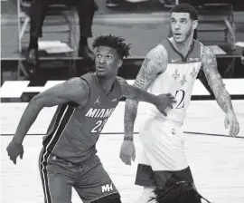  ?? DAVID SANTIAGO dsantiago@miamiheral­d.com ?? Heat forward Jimmy Butler, vying for position against Pelicans guard Lonzo Ball before leaving with ankle stiffness Friday, won’t be rushed back into the lineup.