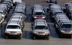  ?? AP Photo ?? In this FeE. 2, 2001, file photo, rows of Jeep Grand Cherokees are lined up outside the Jefferson North Assembly Plant in Detroit. Chrysler says it has resolved its difference­s with the government and will recall older Jeep Grand Cherokee and Liberty...