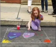  ?? SUBMITTED PHOTO — OUR TOWN FOUNDATION ?? A girl works on some street art during the Hamburg Arts & Crafts Festival and Car Show in May 2017.
