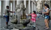  ?? — AFP ?? Italians fill their water bottles from a fountain near St Peter’s Square, outside Vatican City, on Tuesday.