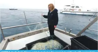  ??  ?? SAVUDRIJA, Croatia: Franka Makovac assists her husband as they prepare to lay out the nets while accompanie­d by a Croatian police patrol boat off Savudrija. —AFP