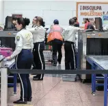  ?? FOTOS DONALDO ZULUAGA ?? 1. Las máquinas detectan objetos no permitidos durante el vuelo. 2. Después de llegar al counter, el equipaje debe pasar por cinco filtros adicionale­s. 3. La Policía requisa a viajeros y a empleados de la terminal aérea. 4. Algunos pasajeros se...