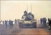  ?? AFP ?? Turkish troops advance near the Syria border at Hassa.
