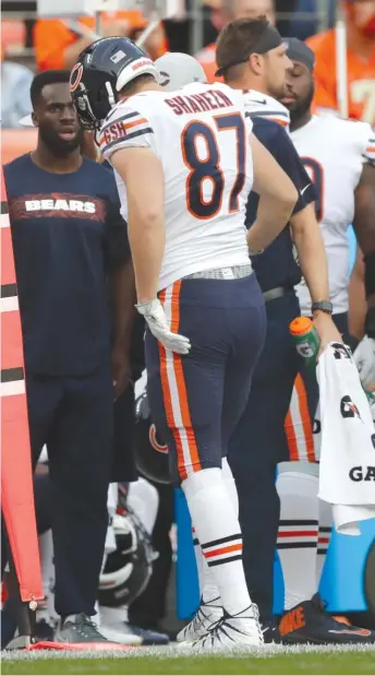  ?? JACK DEMPSEY/AP ?? Bears tight end Adam Shaheen, who injured his ankle, walks off the field after his right foot got caught in the turf in the first quarter Saturday night on a five-yard reception.