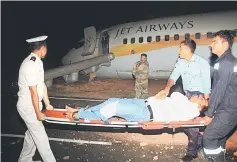  ??  ?? A passenger is stretchere­d after a Jet Airways aircraft skidded off the runway before takeoff at an airport in Goa, India. — Reuters photo