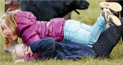  ?? ?? Floored: Mia’s older cousin has no chance as the four-year-old pins her to the ground