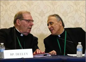  ?? JOSE LUIS MAGANA / AP ?? Portland Bishop Robert Deeley, left, and Cardinal Daniel DiNardo speak at the U.S. Conference of Catholic Bishops meeting Tuesday in Baltimore.