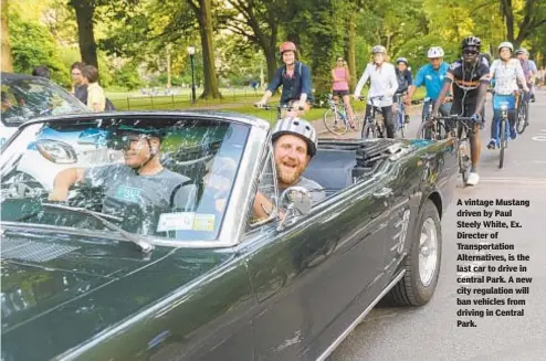  ?? ANDREW SAVULICH/DAILY NEWS ?? A vintage Mustang driven by Paul Steely White, Ex. Directer of Transporta­tion Alternativ­es, is the last car to drive in central Park. A new city regulation will ban vehicles from driving in Central Park.