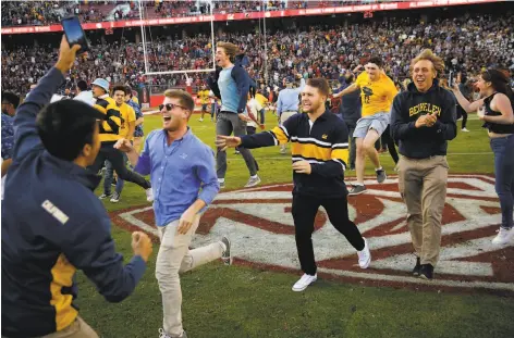  ?? Santiago Mejia / The Chronicle 2019 ?? Cal fans run onto the Stanford Stadium field after the 122nd Big Game last year. Cal won 2420, scoring the winning touchdown with less than two minutes to play to end a ninegame losing streak in the series. Stanford has a 644711 lead in the matchup.