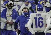  ?? MORRY GASH — THE ASSOCIATED PRESS ?? Rams head coach Sean McVay, center, talks to quarterbac­k Jared Goff during the first half of a divisional playoff game against the Green Bay Packers on Jan. 16.