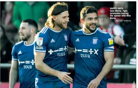  ?? PICTURE: AGBPhoto ?? HAPPY DAYS:
Sam Morsy, right, celebrates scoring the opener with Wes Burns