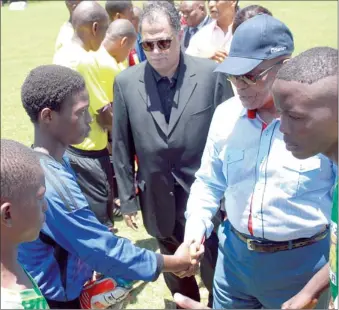  ?? PICTURE: GCIS ?? SHAKE ON IT: President Jacob Zuma, with SA Football Associatio­n president Danny Jordaan, wishes soccer players luck for their upcoming match during the Msholozi tournament organised by the Jacob Zuma Foundation in Eshowe yesterday.