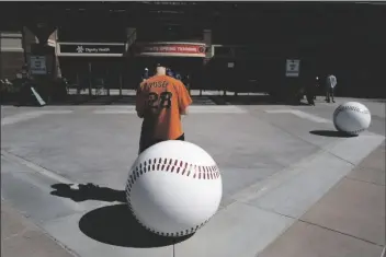  ?? ASSOCIATED PRESS ?? DAN MUNSON waits for the gates to open at Scottsdale Stadium before a spring baseball game between the San Francisco Giants and the Los Angeles Angels in Scottsdale on Sunday.