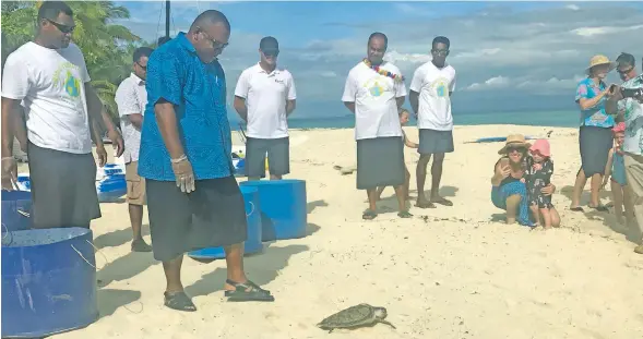  ?? Photo: Charles Chambers ?? Minister for Agricultur­e, Rural and Maritime Developmen­t and National Disaster Management, and Meteorolog­ical Services Inia Seruiratu releases a turtle during the World Turtle Day 2018 celebratio­n at Treasure Island on May 23, 2018.