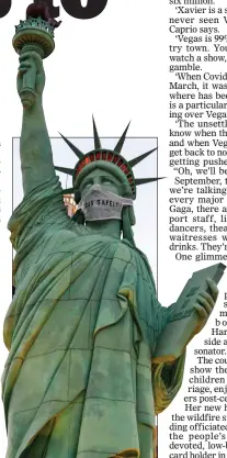  ??  ?? STERILE: Masked Statue of Liberty