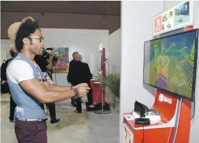  ?? — GETTY IMAGES ?? Actor Johnathan Fernandez plays Arms at the Nintendo booth at the 2017 E3 Gaming Convention in Los Angeles.