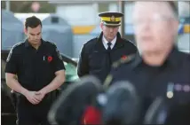  ?? The Canadian Press ?? Police officers listen while Abbotsford Police Chief Bob Rich announces a local officer died Monday after a shootout.