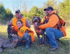  ?? PHOTO CONTRIBUTE­D BY LARRY CASE ?? From left, West Virginia DNR Officer Josh Lambert, youth hunt participan­t Lilly Lambert, Gunner the tracking dog and Chad McCoy of Longspur Tracking and Outfitting pose for photos after a successful day in Monroe County, W.Va.