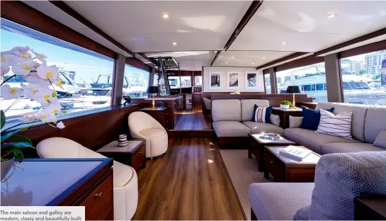  ?? ?? The main saloon and galley are modern, classy and beautifull­y built