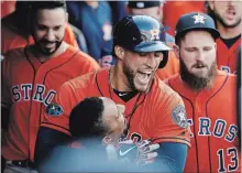  ?? GREGORY SHAMUS GETTY IMAGES ?? George Springer of the Houston Astros celebrates with Tony Kemp after hitting a homer against the Indians in Cleveland on Monday.