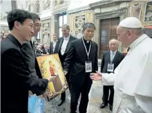  ?? GETTY IMAGES ?? Pope Francis, right, welcomes participan­ts of the internatio­nal disarmamen­t symposium at the Vatican.