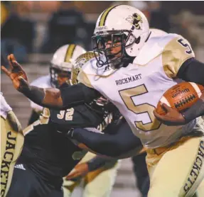  ?? Ryan Gibson/CT ?? Rockmart’s Jermonte Thompson runs for a short gain in the first half against a stout Calhoun defense, who held the Jackets to just 14 points in the first round of the playoffs on Nov. 14.