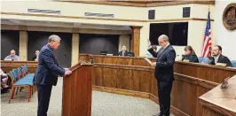  ?? CONTRIBUTE­D ?? K. Philip Callahan (left), Monroe’s law director, swears in Larry Lester as city manager during a recent City Council meeting.