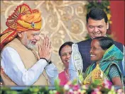  ?? PTI ?? ■ PM Modi with a beneficiar­y of the PMAY scheme in Shirdi on Friday. Maharashtr­a CM Devendra Fadnavis can also be seen.