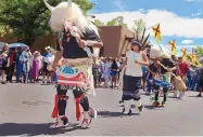  ?? JIM THOMPSON/JOURNAL ?? Buffalo Dancers of the Serpent Trail Dance Group from Ohkay Owingeh pueblo perform on the street at the 97th Santa Fe Summer Indian Market in 2018.