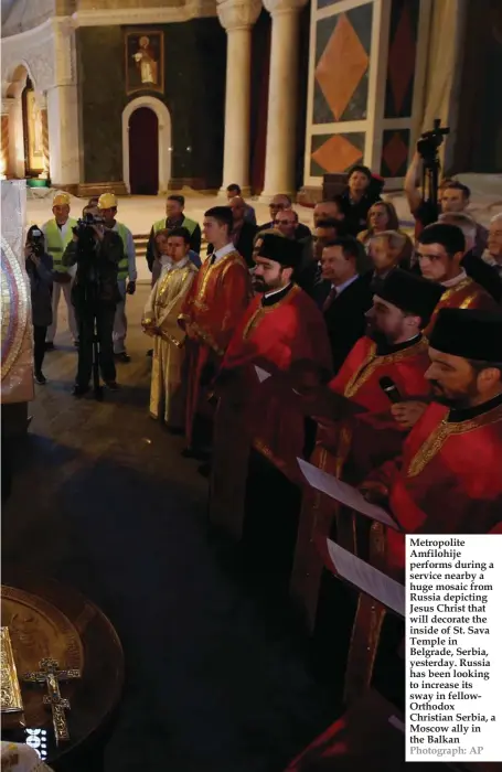  ??  ?? Metropolit­e Amfilohije performs during a service nearby a huge mosaic from Russia depicting Jesus Christ that will decorate the inside of St. Sava Temple in Belgrade, Serbia, yesterday. Russia has been looking to increase its sway in fellowOrth­odox...