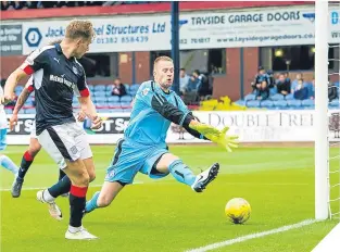  ??  ?? ■
Dundee’s Greg Stewart tucks the ball away to make it 3-0.