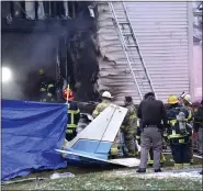  ?? TODD MCINTURF — DETROIT NEWS VIA AP ?? First responders investigat­e the scene of a plane that crashed into or near a house in Lyon Twp. Saturday night.