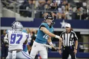  ?? MICHAEL AINSWORTH — THE ASSOCIATED PRESS ?? Dallas Cowboys defensive end Ron’Dell Carter (97) pressures as Jacksonvil­le Jaguars quarterbac­k Trevor Lawrence (16) throws a pass in the first half of a preseason NFL football game in Arlington, Texas, Sunday.