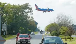  ?? BALTIMORE SUN FILE ?? A plane flies over Dorsey Road in Glen Burnie in 2016 as it prepares to land at BWI Marshall Airport.