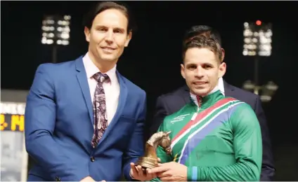  ?? Picture: Singapore Turf Club ?? KING OF THE WORLD. Aldo Domeyer receives his trophy for winning the Victor Ludorum at the Premier Gateway Internatio­nal Jockeys Challenge in Singapore yesterday. He won Race 4 aboard Safeer and together with his seventh place in the second leg, third place in the opening leg and sixth place in the final leg, it was enough to secure the individual title. (See Back Page)