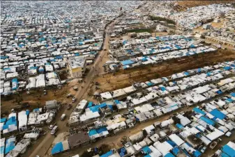  ?? Omar Albam / Associated Press ?? The Karama camp shelters internally displaced Syrians near the village of Atma in Idlib province. The U.N. says millions of Syrians will depend on humanitari­an assistance this year.