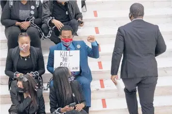  ?? BEN GRAY/AP ?? Protesters opposed to changes in Georgia’s voting laws at the State Capitol in Atlanta on Monday. Many proposed changes in voting across the country would disproport­ionately affect groups that historical­ly vote for Democrats.