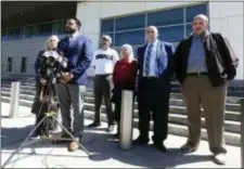  ?? RED HUBER — ORLANDO SENTINEL VIA AP ?? Susan Clary, spokespers­on for Noor Salman’s family, Ahmed Bedier, President, United Voices For America, second from left, and the four members of Noor Salman’s family, right, address the media Wednesday outside the Federal courthouse in Orlando, Fla.