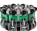  ??  ?? Graphique cuff in white gold set with malachite, onyx and diamonds