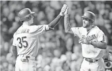  ?? DENNIS WIERZBICKI, USA TODAY SPORTS ?? The Dodgers’ Chris Taylor celebrates with Cody Bellinger after hitting a home run on Tuesday.