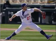  ?? ROSS D. FRANKLIN — THE ASSOCIATED PRESS ?? In a Monday, March 1, photo, Los Angeles Dodgers pitcher Trevor Bauer throws against the Colorado Rockies during the first inning of an exhibition game in Phoenix.